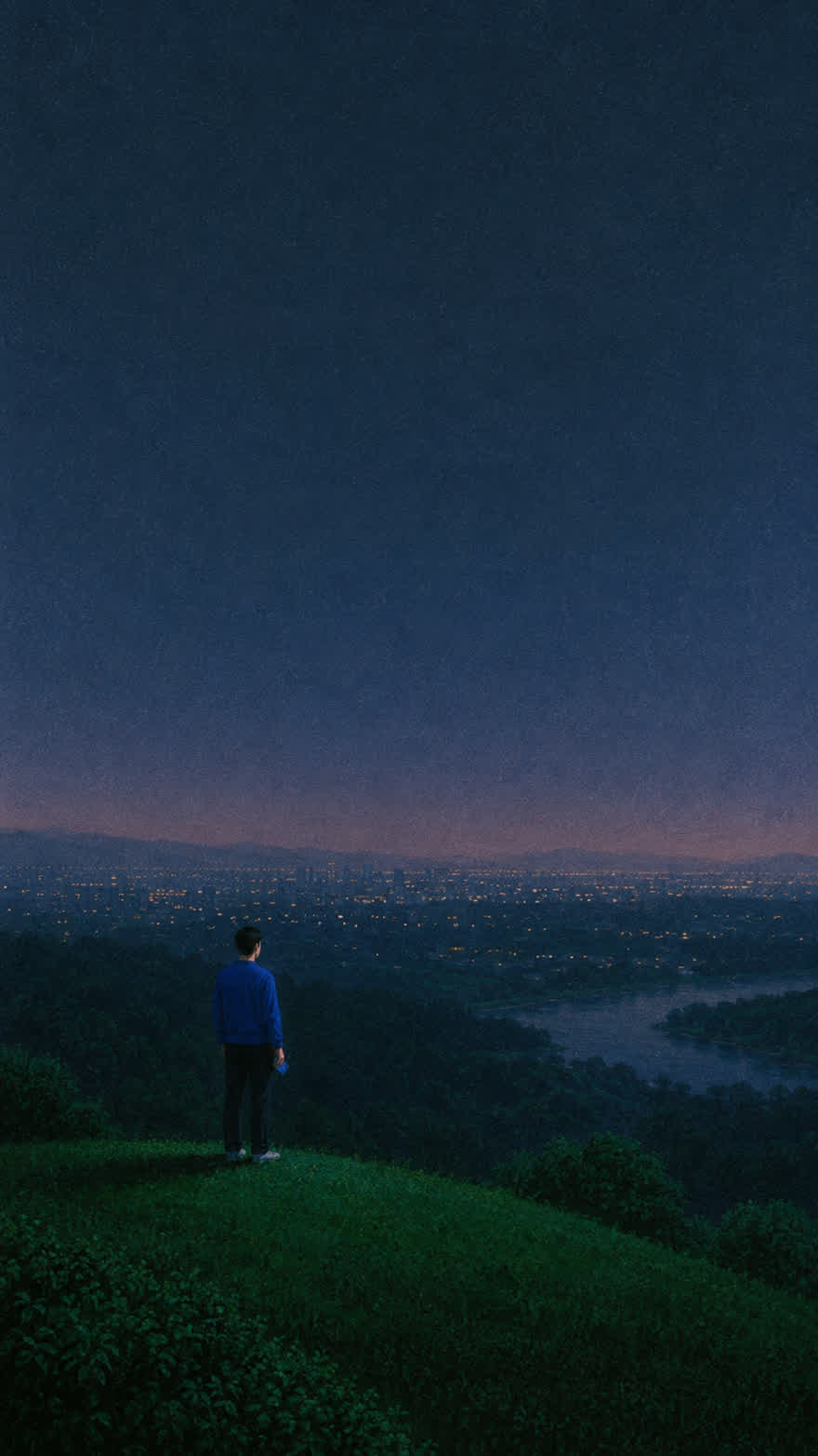 A ridge above the city at dusk, the phone small in his hand